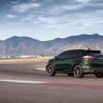 A green 2024 Ford Edge ST is shown from the rear at an angle.