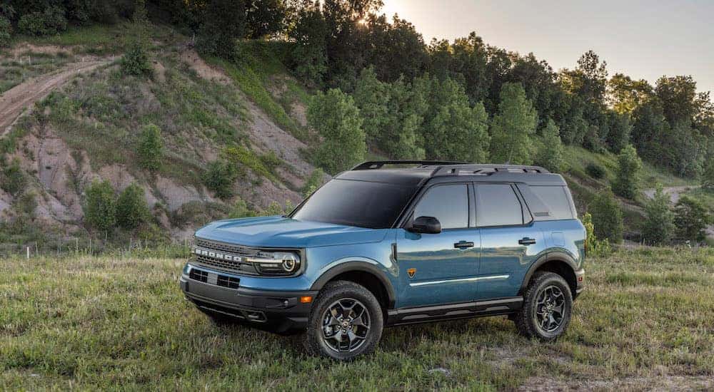 A blue 2024 Ford Bronco Sport Badlands is shown from the side after leaving a dealer that has a used Ford for sale near Troy.