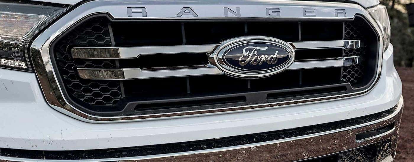 A close up of the grille on a white used 2023 Ford Ranger for sale at a dealership.