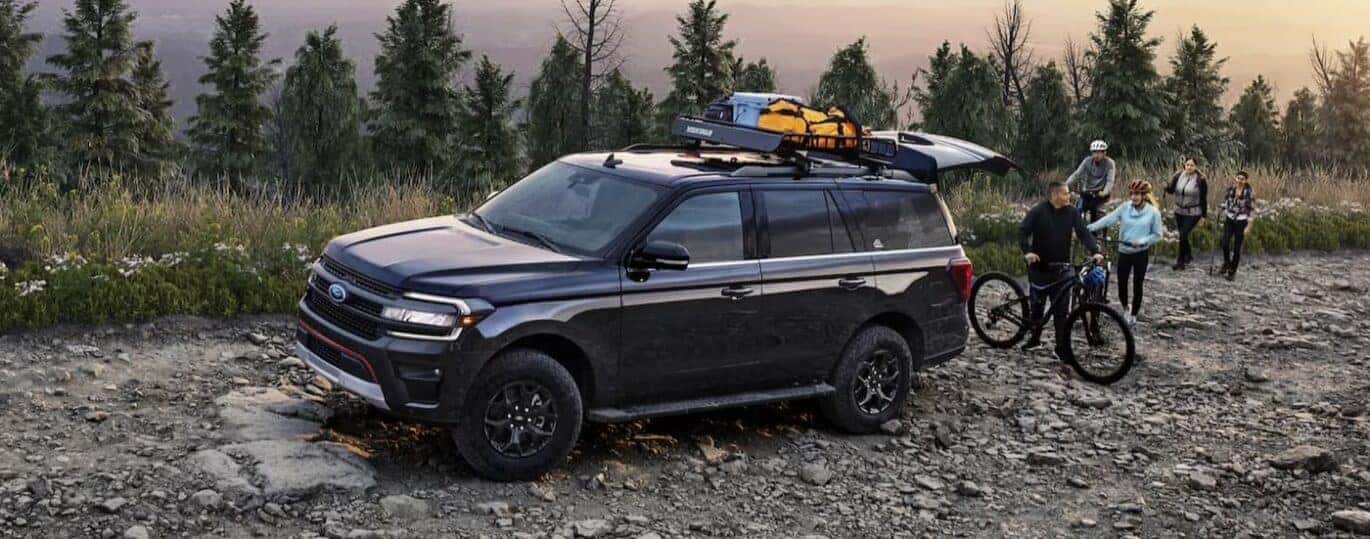 A black 2024 Ford Expedition Timberline is shown parked on a rocky road.