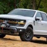 A white 2024 Ford F-150 Tremor is shown from the front at an angle.