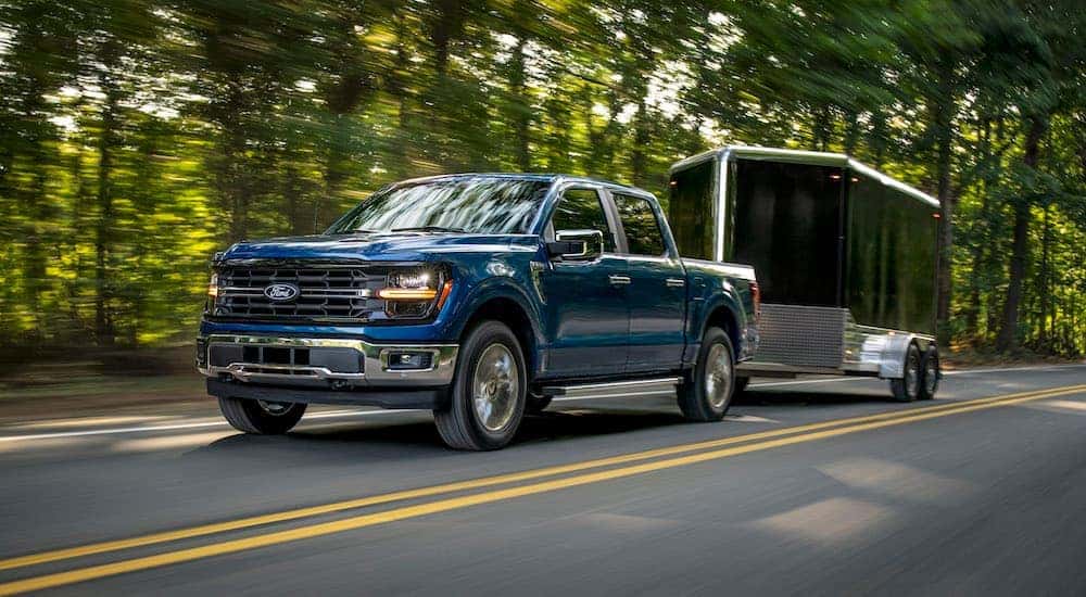 A blue 2024 Ford F-150 XLT is shown from the front at an angle.