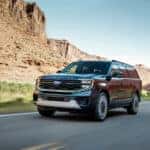 A grey 2025 Ford Expedition Platinum Ultimate is shown from the front at an angle.