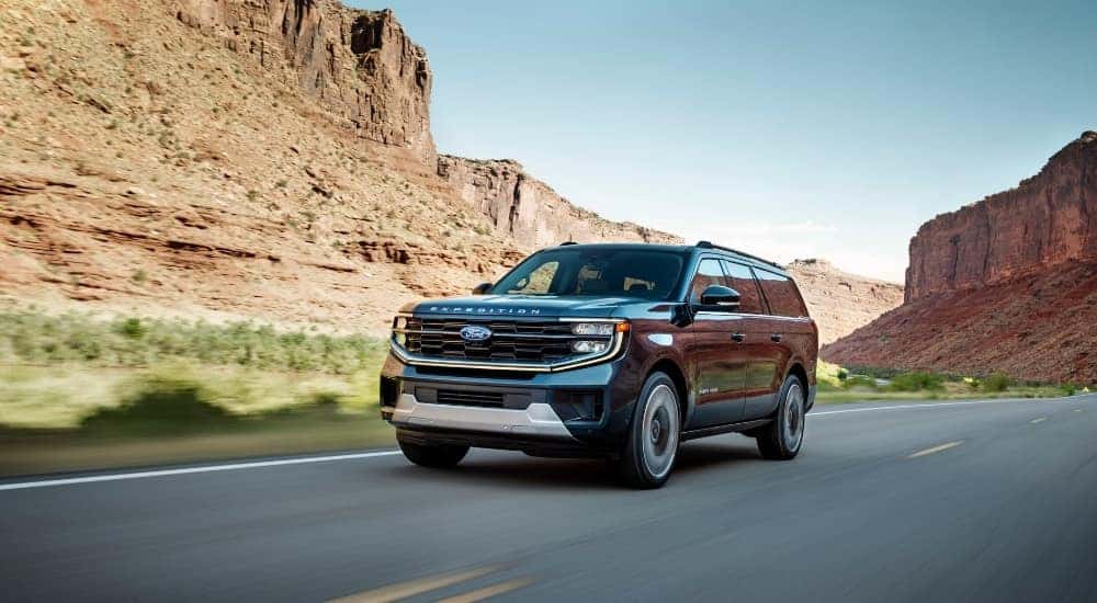 A grey 2025 Ford Expedition Platinum Ultimate is shown from the front at an angle.