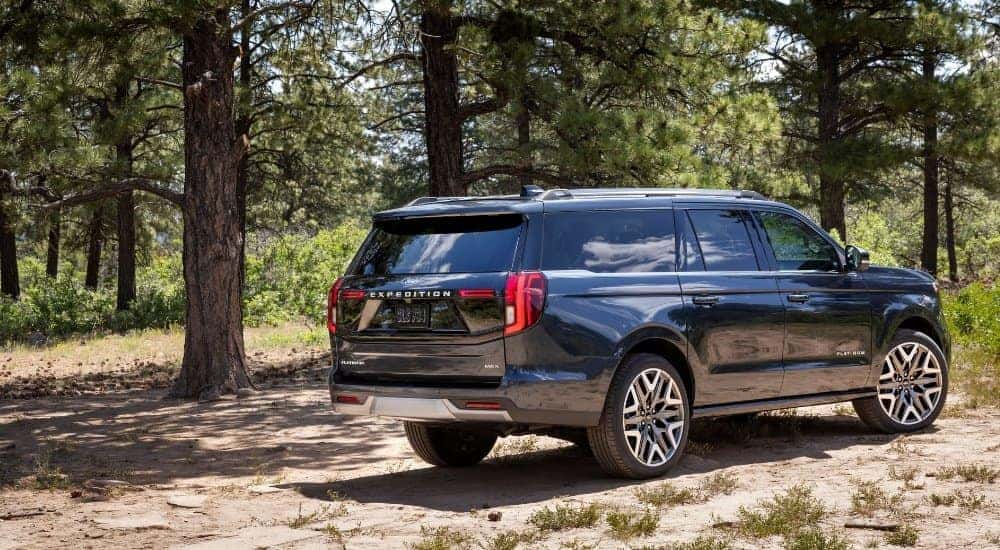A grey 2025 Ford Expedition Platinum Ultimate is shown from the rear at an angle.
