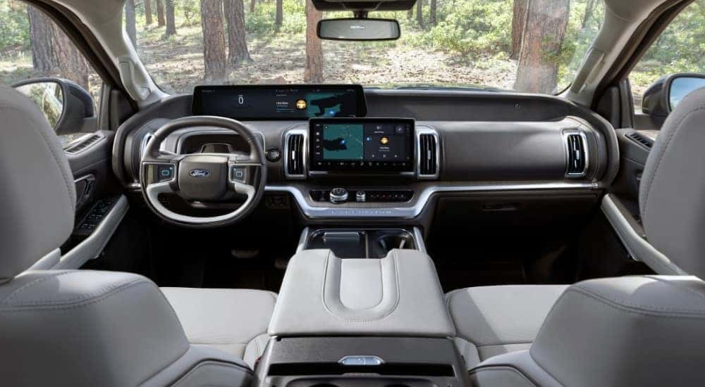 The white interior 2025 Ford Expedition for sale is shown from the rear seat.