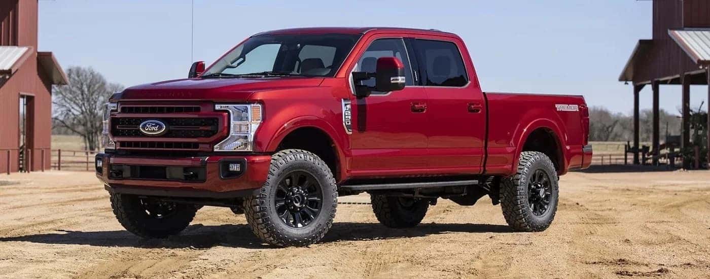 A red 2022 Ford F-250 Lariat is shown from the front at an angle.