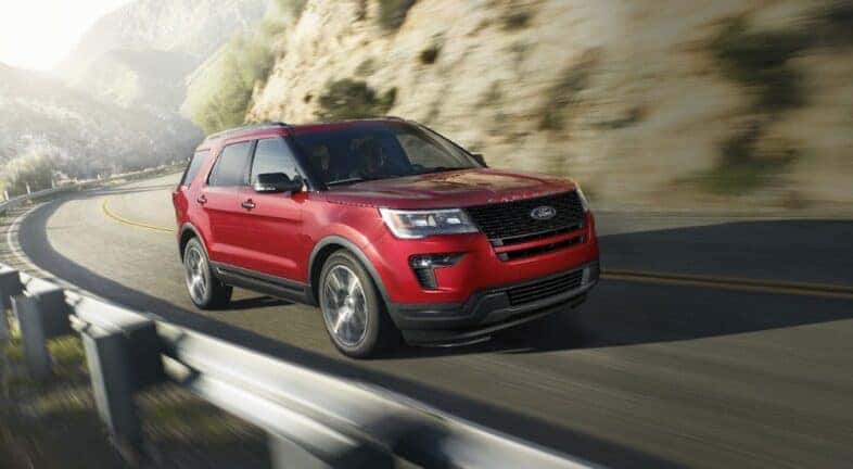 A red 2019 Ford Explorer is shown driving after viewing a used Ford for sale in Colonie.