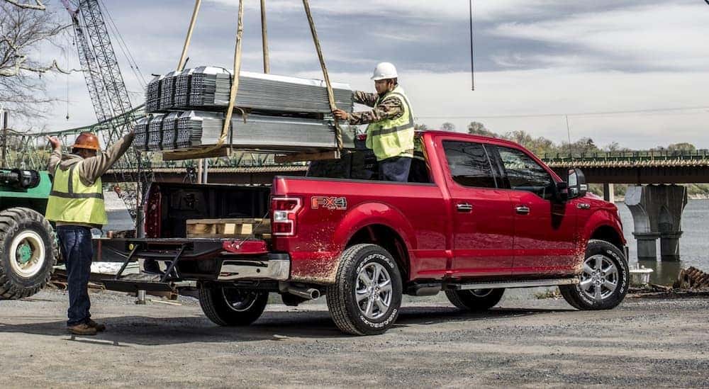 A red 2020 Ford F-150 is shown parked on a construction site.