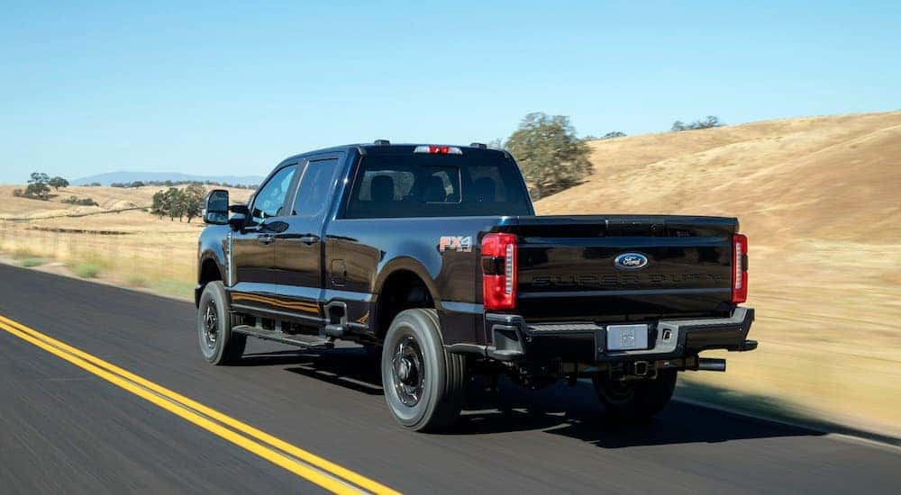 A black 2025 Ford F-250 XL STX is shown from the rear at an angle.