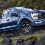 A blue 2023 Ford F-150 STX is shown from the side after leaving a dealer that has a used Ford F-150 for sale near Delmar.