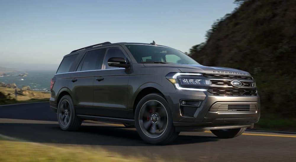 A grey 2022 Ford Expedition is driving on an open highway.