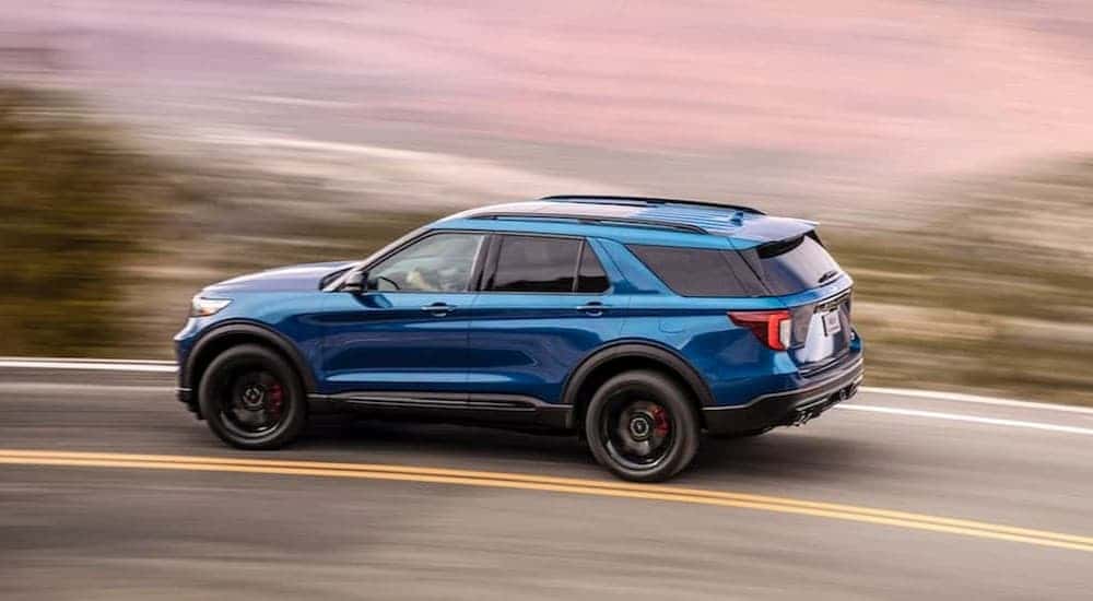 A blue 2020 Ford Explorer ST is shown driving on a highway after viewing a used Ford Explorer for sale near Colonie.
