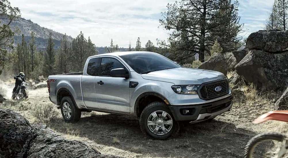 A silver 2024 Ford Ranger STX is shown parked off-road.