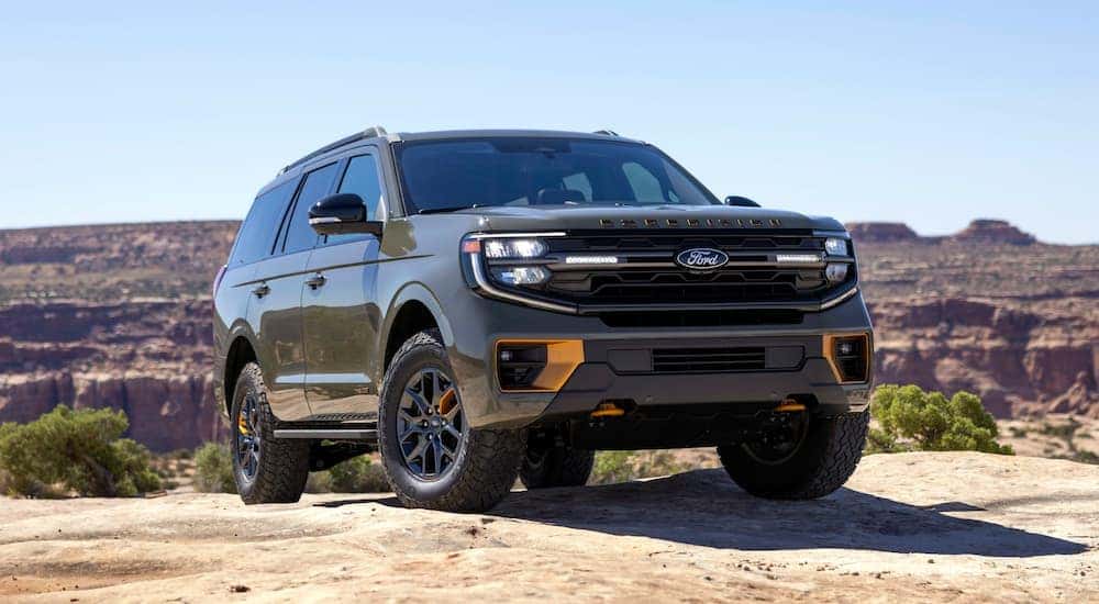 A dark green 2025 Ford Expedition Tremor parked off-road and angled right.