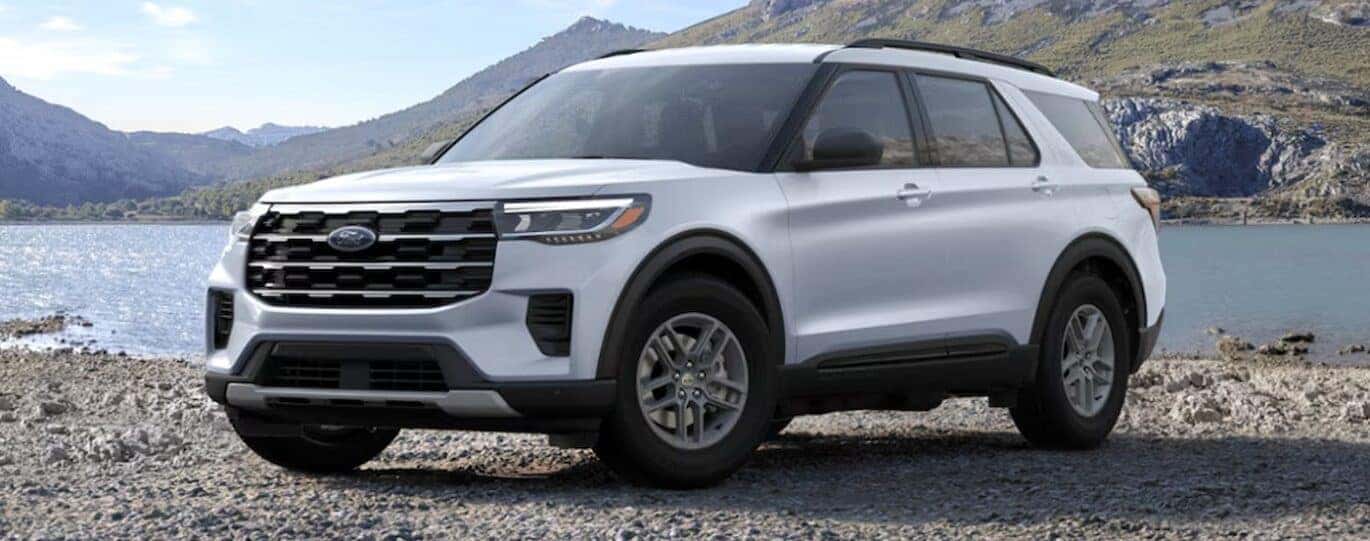 A white 2025 Ford Explorer Active is shown parked near a lake.