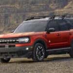 A red 2024 used Ford Bronco Sport for sale in Albany is shown from the front at an angle.