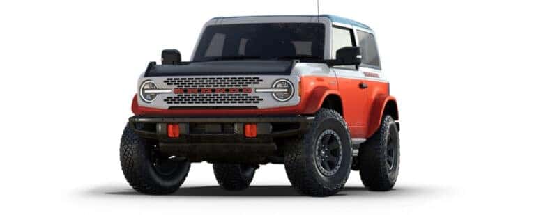 An orange and white 2025 Ford Bronco Stroppe Edition is angled left.