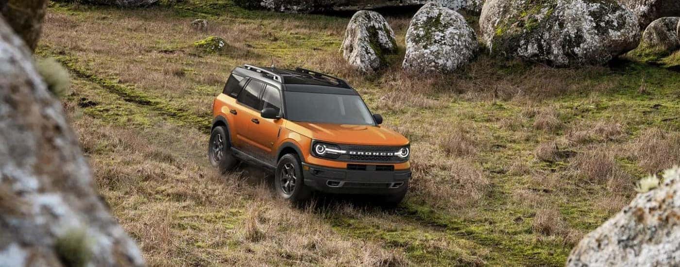 An orange 2023 Ford Bronco Sport Badlands is shown off-roading after viewing a used Ford Bronco Sport in Albany.