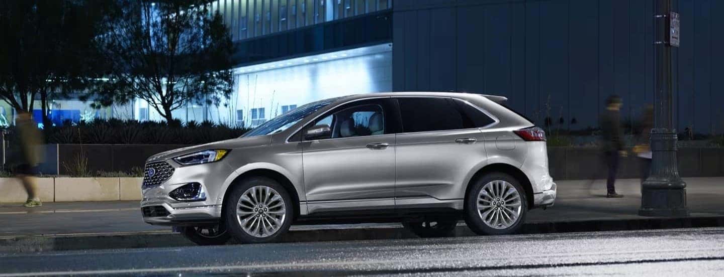 A silver 2024 Ford Edge is shown parked on a city street.