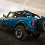 A blue 2025 Ford Bronco is shown from the rear at an angle.