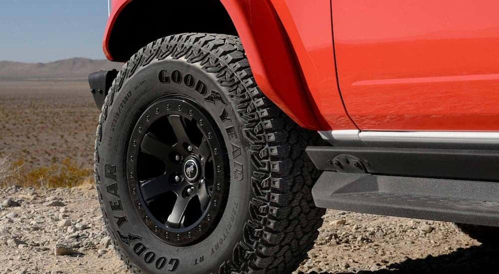 A close up of the rim and tire on a red 2025 Ford Bronco Stroppe Edition.