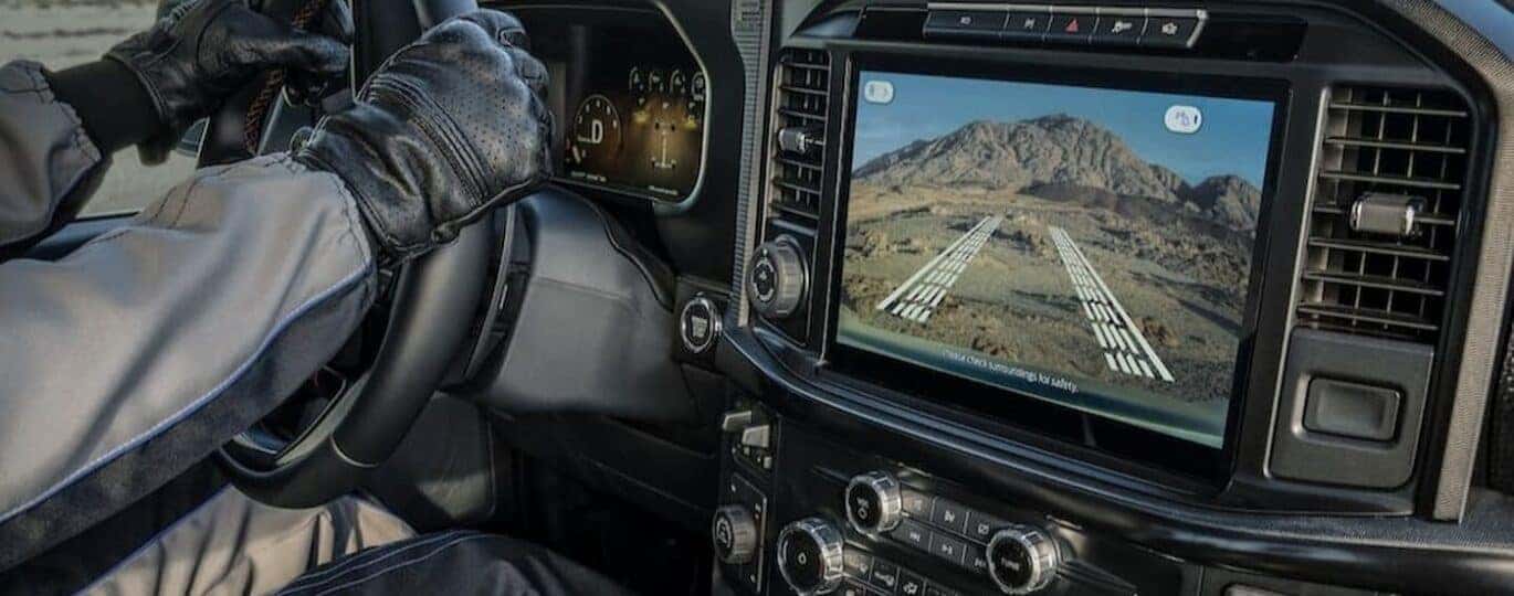 A close-up of the infotainment screen is shown in a 2025 Ford F-150.