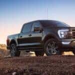 A black 2022 Ford F-150 is shown from the front after leaving a dealer that has a used Ford for sale near Cohoes.