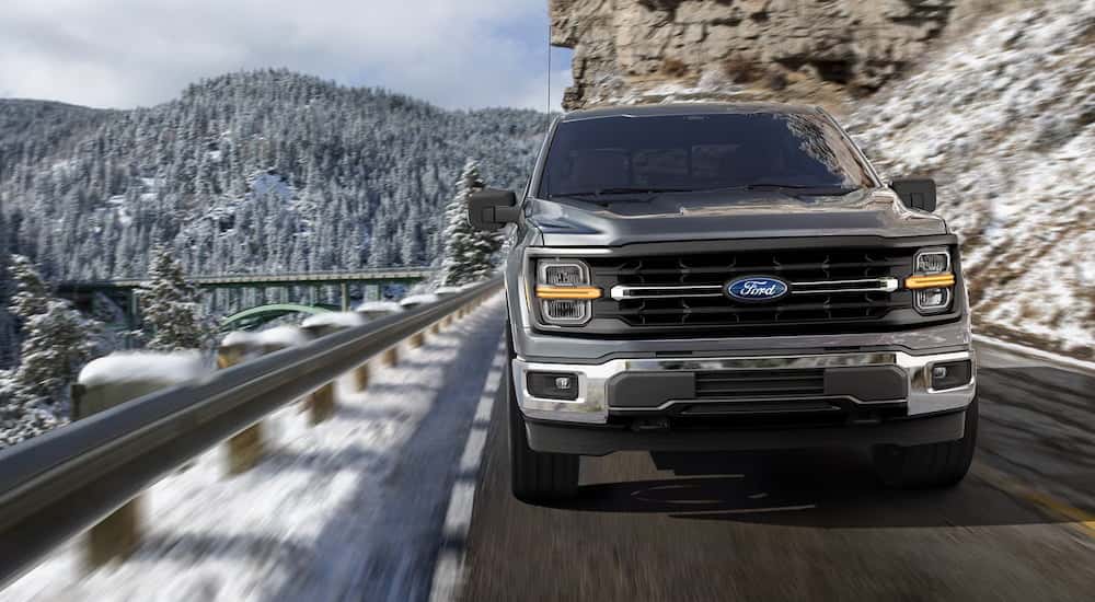A grey 2025 Ford F-150 driving down a mountain road.