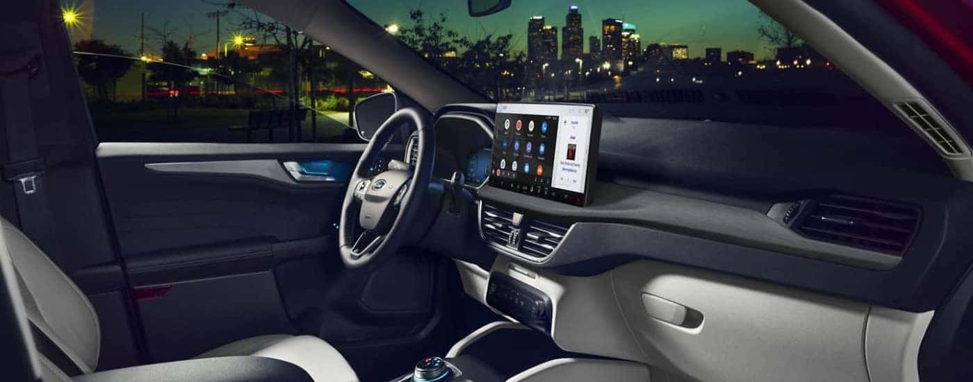 Side angle view of the black interior cabin of a 2024 Ford Escape.