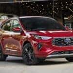 A red 2025 Ford Escape PHEV parked on cement.