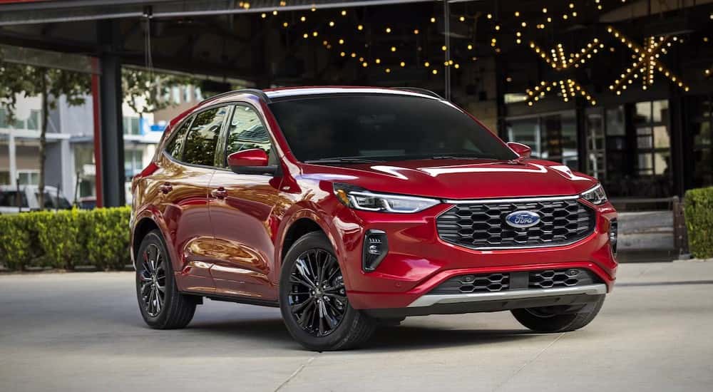 A red 2025 Ford Escape PHEV parked on cement.