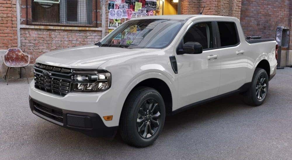 A white 2023 Ford Maverick Lariat parked near a wall.