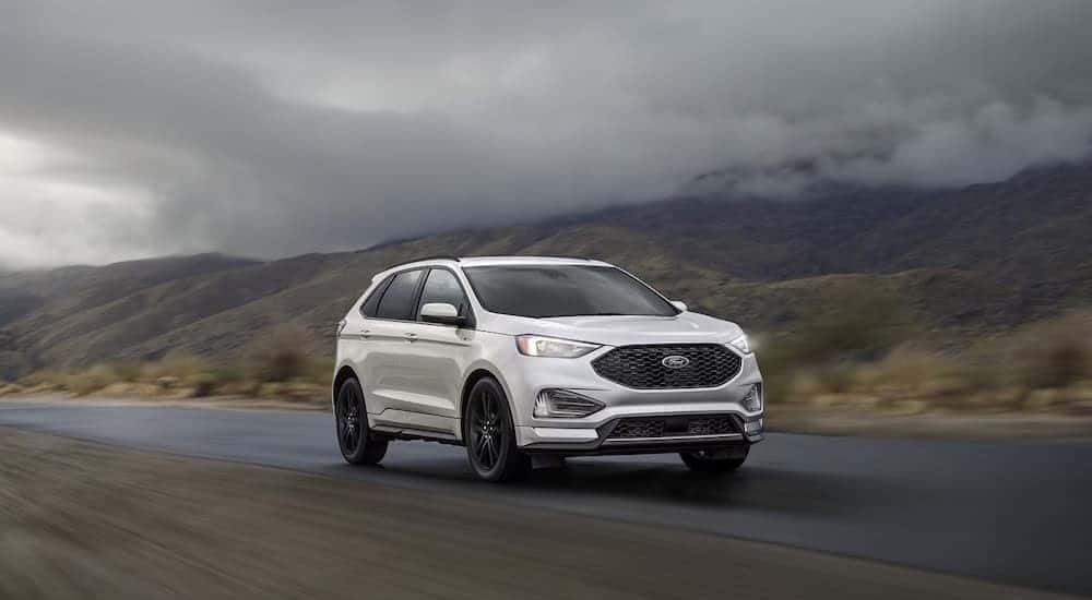 A white 2023 Ford Edge driving on a foggy day.