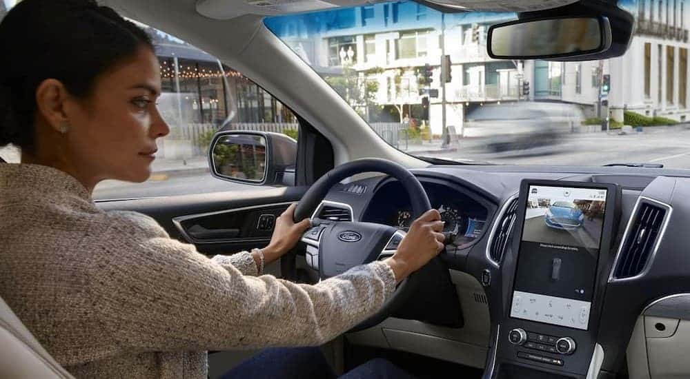 A person driving in a 2024 Ford Edge.