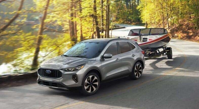 Silver 2024 Ford Escape towing a boat