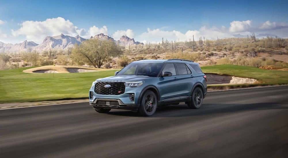 A blue 2025 Ford Explorer ST driving on a highway.