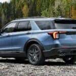 A blue 2025 Ford Explorer ST Line parked off-road.