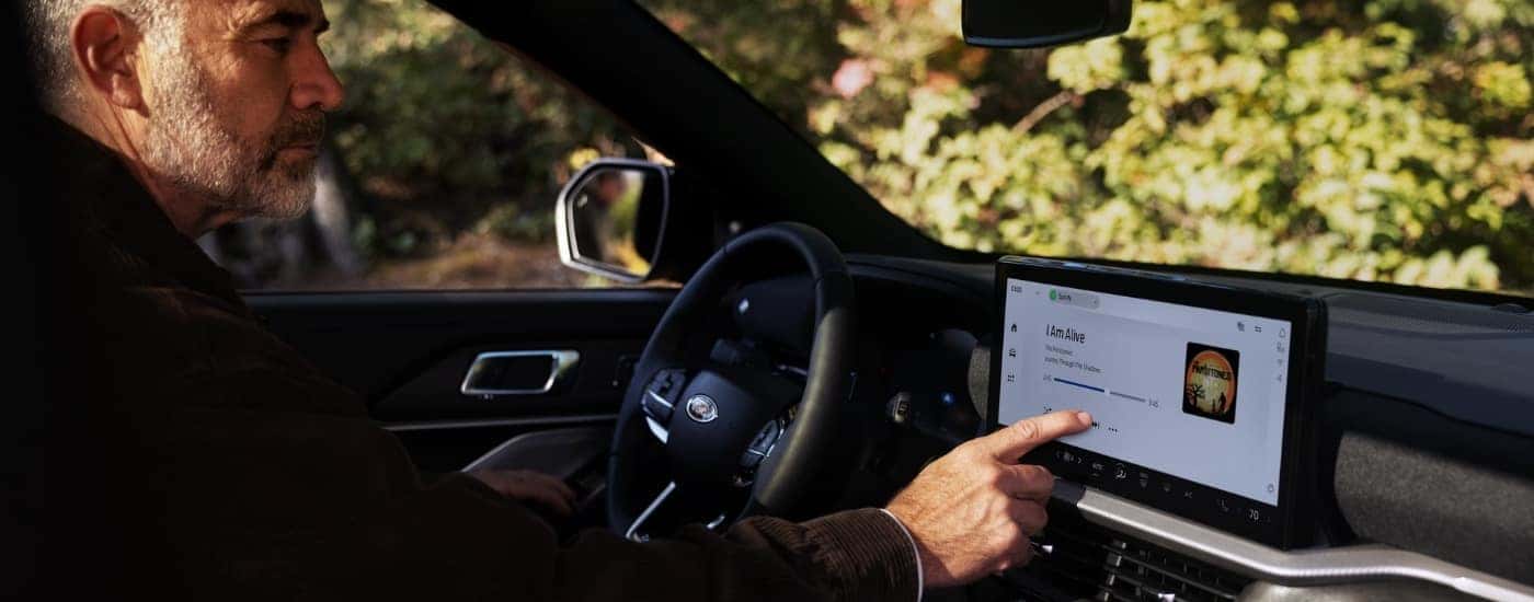 A person using the touchscreen in a 2025 Ford Explorer.