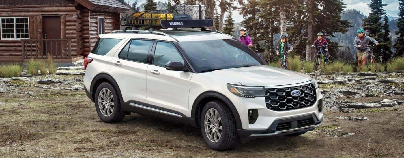 Bikers near a white 2025 Ford Explorer.