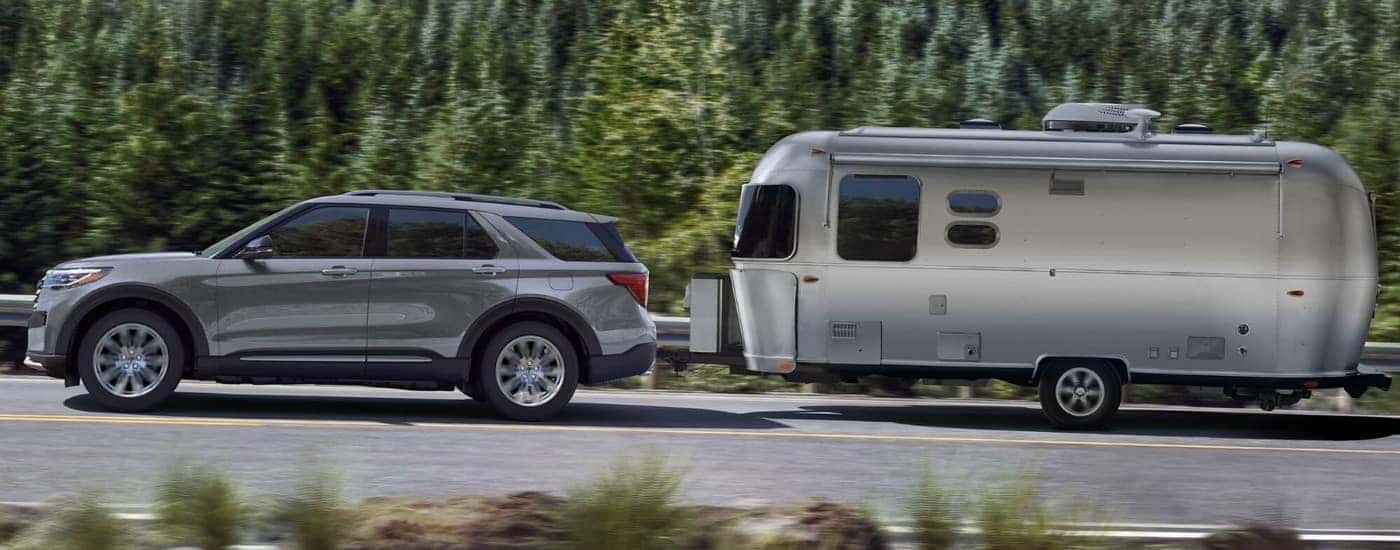 A grey 2025 Ford Explorer towing an Airstream.