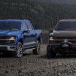 Blue 2025 Ford F-150 STX and brown 2025 Ford F-150 Tremor parked near a lake.