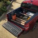The bed of a red 2025 Ford Maverick from a high angle.