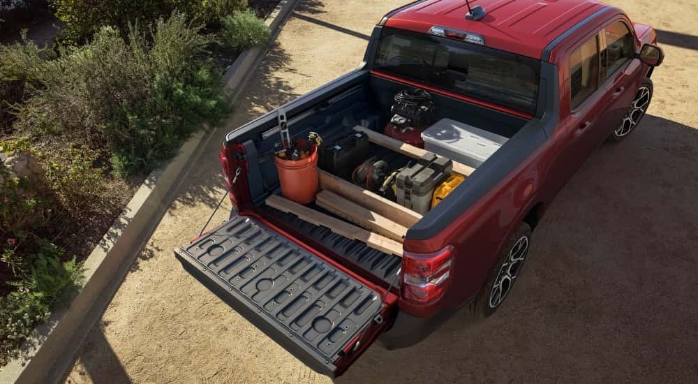 The bed of a red 2025 Ford Maverick from a high angle.