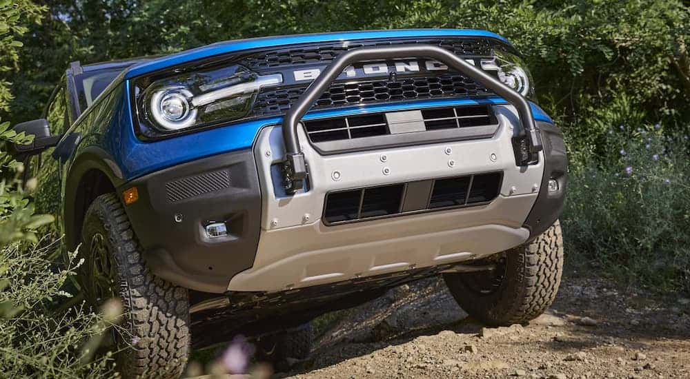 A blue 2025 Ford Bronco Sport vs 2025 Jeep Compass