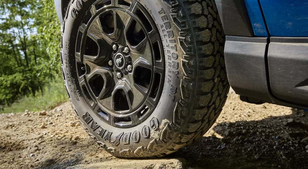 Tire and rim on a blue 2025 Ford Bronco Sport parked off-road