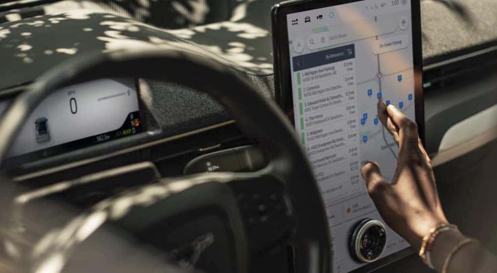 Close-up of a person using the infotainment screen in a 2025 Ford Mustang Mach-E.