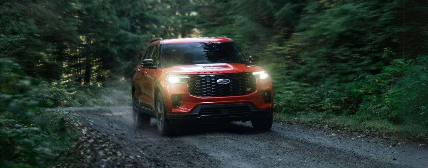 A red 2025 Ford Explorer ST off-roading on a trail