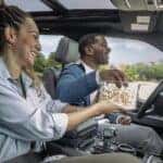 Two people eating popcorn in a 2025 Ford F-150 Lightning.