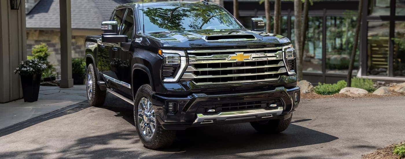 Black 2024 Chevy Silverado 2500HD High Country parked in a driveway